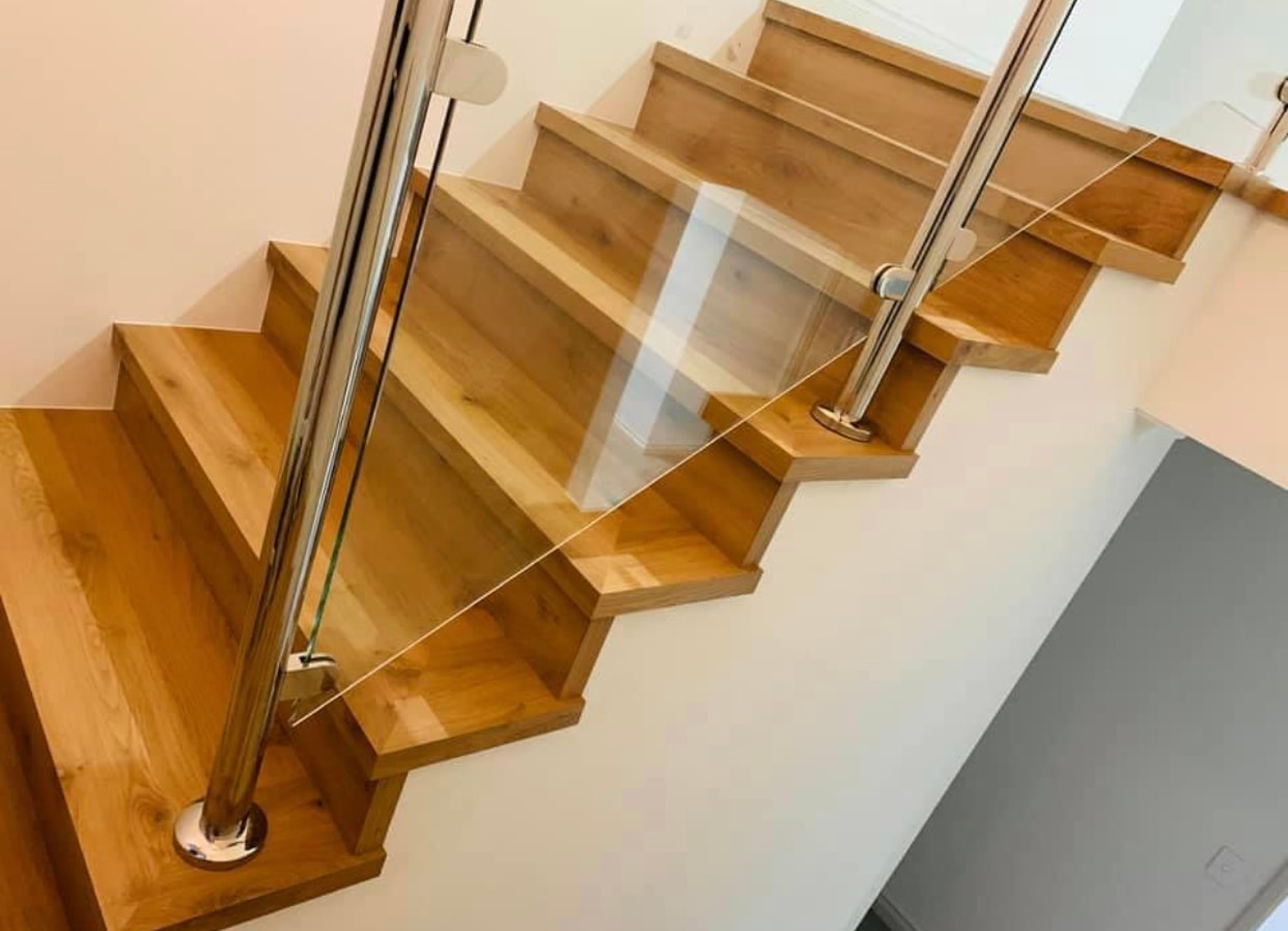 Wooden staircase with glass railing overhead view