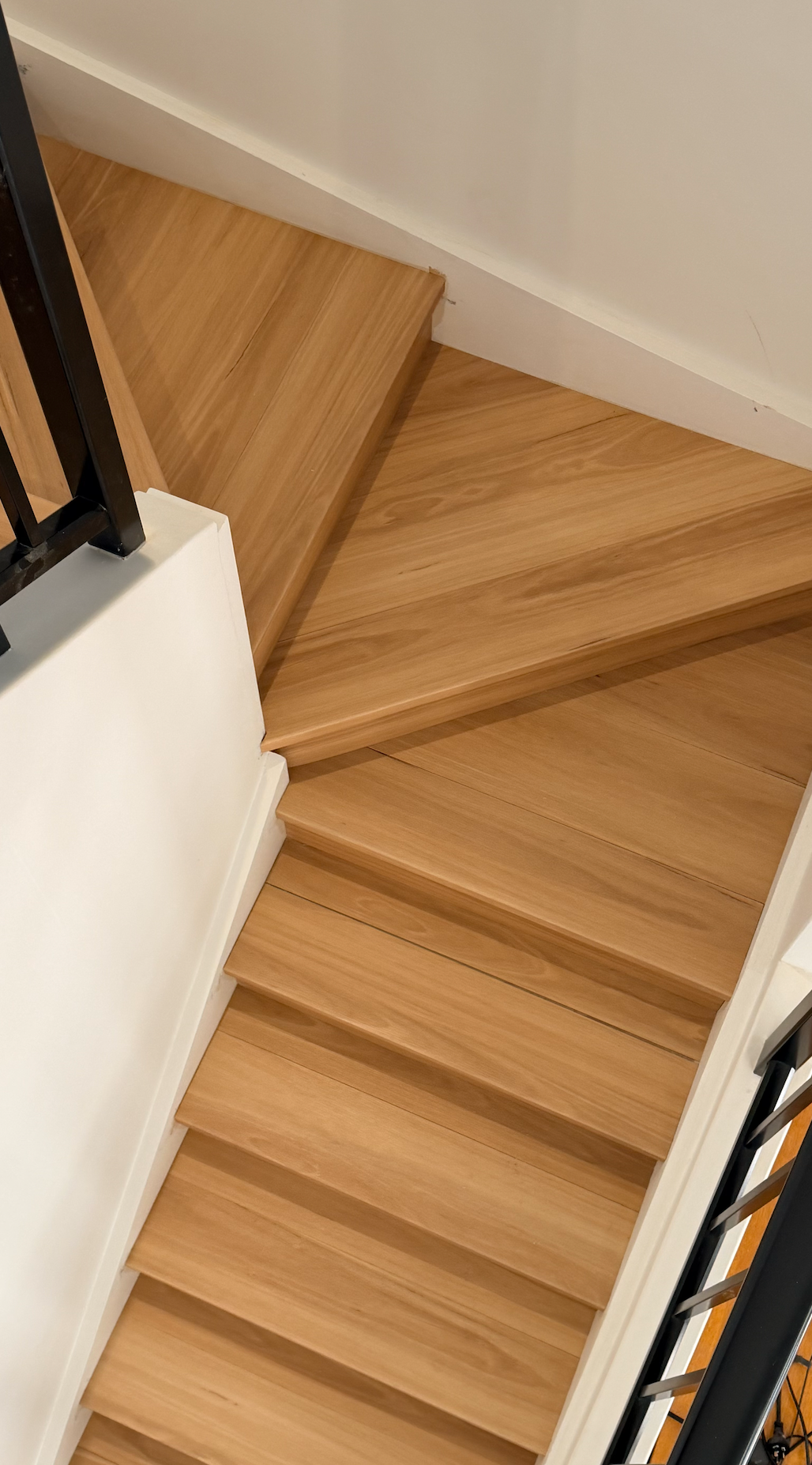 Wooden staircase with white walls